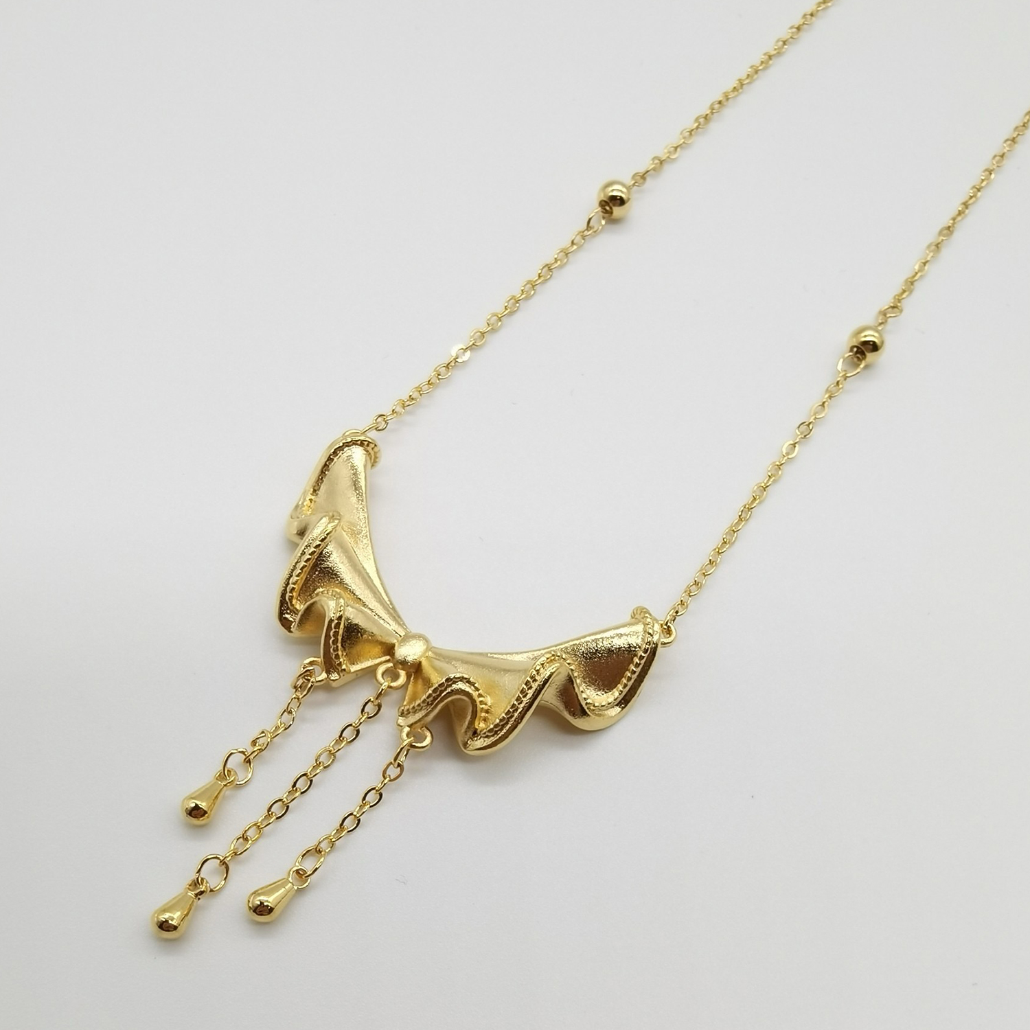 Alluvial gold vacuum electroplating 24K gold bow tassel necklace